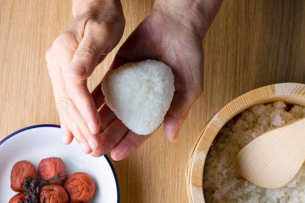 What role does rice play in the health benefits of onigiri?